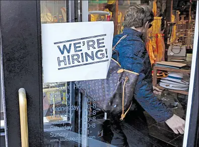  ?? AP/CHARLES KRUPA ?? A shopper enters a clothing store in Boston’s Downtown Crossing shopping center in this file photo. U.S. employers in April advertised the most open jobs since 2000, the Labor Department reported Tuesday.