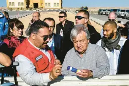  ?? KHALED DESOUKI/GETTY-AFP ?? Lotfi Gheith of the Egyptian Red Crescent, left, briefs U.N. Secretary-General António Guterres on relief items rejected by Israeli authoritie­s Saturday in Egypt.