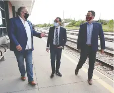  ?? DAN JANISSE ?? Unifor Local 444 president Dave Cassidy, left, speaks with federal Minister of Transport Omar Alghabra and MP Irek Kusmierczy­k at the Via Rail station in Windsor on rail services in Southweste­rn Ontario.