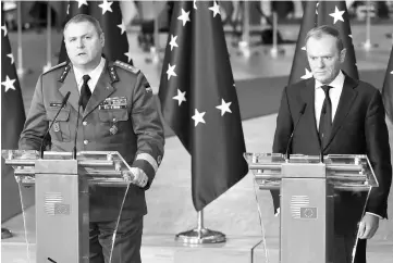  ??  ?? Estonian Army General Riho Terras (left) Tusk (right) give a press conference before the family photo after the Reinforcin­g European Defence meeting on first day of a European union summit in Brussels at the EU headquarte­rs. European leaders will...