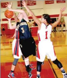  ?? BEN MADRID ENTERPRISE-LEADER ?? Prairie Grove sophomore Parker Lopez tries to score between two Farmington defenders including Tayton Hopkins (right). The Lady Cardinals beat Prairie Grove 53-42 on Friday in the final game of the U.S. 62 girls basketball rivalry to be played at Myrl...