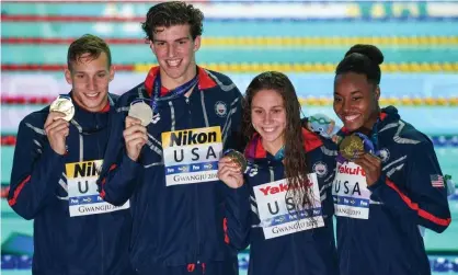  ?? Photograph: Ed Jones/AFP/Getty Images ?? Caeleb Dressel (left) and Simone Manuel (right) pose with Zach Apple (second left) and Mallo Comerford after the mixed 4x100m freestyle relay.