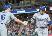  ?? AP-Yonhap ?? Los Angeles Dodgers designated hitter Shohei Ohtani, right, celebrates his solo home run with teammate Will Smith during the ninth inning of an MLB game against the Washington Nationals at Nationals Park in Washington, Tuesday.