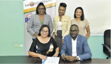  ?? ?? Founder of The Honey Bun Foundation Michelle Chong (seated left) and president of the Montego Bay Chamber of Commerce Oral Heaven (right) are joined by (from left, standing): Karlene Maye, second vice-president of the chamber; Damia Dayes, third vice-president; and Nashauna Lalah, general manager of The Honey Bun Foundation, for the signing of a MOU which will provide a boost for the chamber’s members.