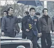  ?? CJ Entertainm­ent ?? KIM YOON-SEOK, center, portrays a ruthless government official in “1987: When the Day Comes.”