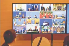  ?? — AFP photo ?? Representa­tives of signatory countries are pictured on screen during the signing ceremony for the RCEP trade pact at the Asean summit that is being held online in Hanoi.