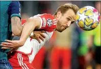  ?? PHOTO: AFP ?? Bayern Munich’s Harry Kane heads the ball against Arsenal in their UEFA Champions League quarter-final second leg at the Allianz Arena in Munich, Germany, on Wednesday.