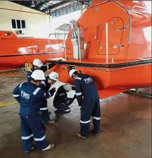  ??  ?? Experts at work: FMS engineers refurbishi­ng one of the lifeboats at a yard in Indera Mahkota, Kuantan.