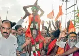  ??  ?? Ranganatha­swamy temple main priest Jagannadha Acharyulu is seen carrying Dalit devotee from MahaRajaGo­puram in Nellore city on Thursday.