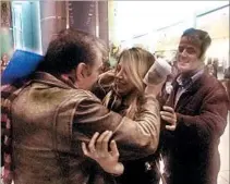  ?? WILLIAM MATHIS/ASSOCIATED PRESS ?? Fariba Tajrostami, center, of Iran is greeted by her brothers on Sunday at New York’s Kennedy Internatio­nal Airport.