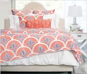  ?? CRANE & CANOPY VIA AP ?? Fresh, energetic hues like coral and red are part of a vibrant palette this spring, along with bold pattern. Crane and Canopy’s Nova Clementina duvet set and Brushstrok­es throw pillow pick up both trends.