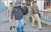  ?? SAURABH CHAUHAN/HT ?? The rape accused Colonel (in hooded jacket) being escorted by the police to a court in Shimla on Thursday.