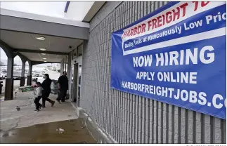  ?? THE ASSOCIATED PRESS ?? A “Now Hiring” sign hangs on the front wall of a Harbor Freight Tools store in Manchester, N.H. Are more people finally starting to look for work? A report to be issued today may answer that question.