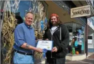  ?? BARRY TAGLIEBER — 21ST CENTURY MEDIA ?? Steve Leva of the Phoenixvil­le Smoke Shop, right, accepts a certificat­e for first place from Mayor Mike Speck in this year’s Halloween window decorating contest for businesses.