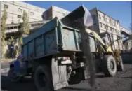  ?? THE ASSOCIATED PRESS ?? Coal is loaded onto a truck at the Chelyuskin­tsev coal mine in the city of Donetsk, eastern Ukraine. Heavy fighting and electricit­y blackouts have paralyzed the work of dozens of mines in the region, whose capital, Donetsk, was founded in the late 19th...