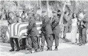  ?? PHOTOS BY MIKE STOCKER/STAFF PHOTOGRAPH­ER ?? At top, Myeshia Johnson, the wife of Army Sgt. La David Johnson, kisses her husband’s casket at Hollywood Memorial Gardens. Above, pallbearer­s carry Johnson’s casket to the cemetery on Saturday.