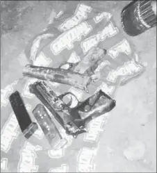  ??  ?? The two handguns and magazines with matching ammunition that were found after the attack