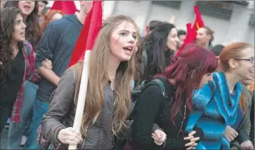  ?? Louisa Gouliamaki
AFP/Getty Images ?? GREEK demonstrat­ors shout slogans during a march in November. Many young people in the debt-laden and austerity-driven country cannot recall a time when life was good — and doubt it ever will be.