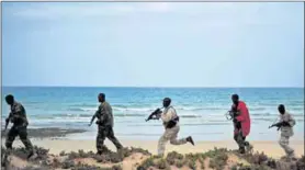  ??  ?? Sensitive: Security forces patrol a section of Somalia’s coastline. Critics oppose moves to exploit oil and gas reserves in the south of the country, saying the administra­tion is corrupt. Photo: Mohamed Abdiwahab/afp