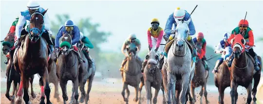  ??  ?? POKER STAR (left), with Omar Walker aboard, powering to victory at Caymanas Park on June 16.