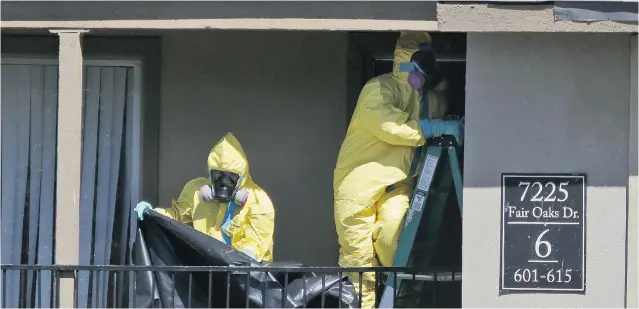  ?? LM OTERO/THE ASSOCIATED PRESS ?? Hazardous-materials cleaners work at the Dallas apartment where Thomas Eric Duncan, the Ebola patient who travelled from Liberia to Dallas, stayed last week.