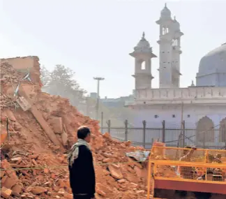  ??  ?? A JANUARY 2019 photograph showing constructi­on work in full swing near the Kashi Vishawanat­hgyanvapi mosque complex at Varanasi for a corridor connecting the temple to the river. The levelling of houses, shops and small temples for the project gave rise to fears that the mosque might become a possible target for demolition.
