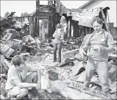  ??  ?? All that’s left: Residents sift through remains of their Santa Rosa home.