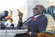  ?? Jekesai Njikizana / AFP / Getty Images ?? Former President Robert Mugabe addresses the media at his private residence in Harare.