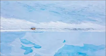  ?? Alaska Department of Transporta­tion and Public Facilities ?? IN ALASKA, a truck travels Dalton Highway, covered in ice from Sagavanirk­tok River overf low. One odd suggestion for solving California’s crisis: Sink pipe on the ocean f loor and siphon water from Alaska.