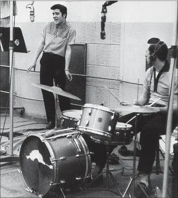  ?? BMG Archive ?? DRUMMER D.J. Fontana accompanie­s Elvis Presley during “Jailhouse Rock” recording in Hollywood in 1957.