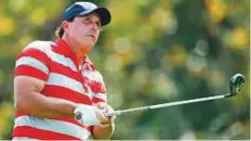  ?? AFP ?? Phil Mickelson watches his shot off the 12th tee during a practice round prior to the Presidents Cup.