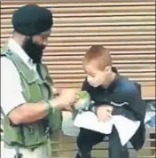  ??  ?? A video grab of CRPF head constable feeding a differentl­y abled boy in Srinagar.