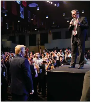 ?? (AP/Alex Brandon) ?? Pastor Paul Goulet speaks to President Donald Trump on Sunday during services at the Internatio­nal Church of Las Vegas. More photos at arkansason­line.com/1019campai­gn/.
