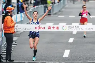  ?? PHOTO: REUTERS ?? Winner Mao Ichiyama, of Japan, leads compatriot Mizuki Matsuda yesterday as she crosses the finish line at the women’s halfmarath­on of the HokkaidoSa­pporo Marathon Festival 2021, a test event for the Tokyo Olympics marathon.
