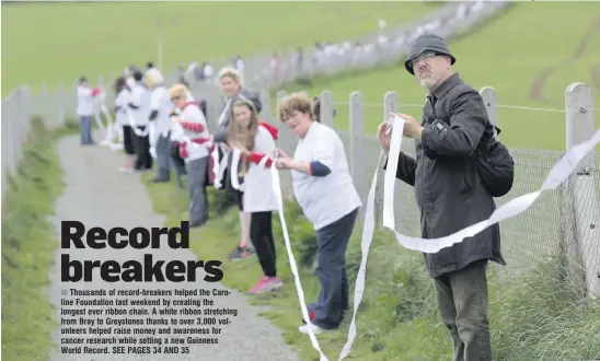  ??  ?? Thousands of record-breakers helped the Caroline Foundation last weekend by creating the longest ever ribbon chain. A white ribbon stretching from Bray to Greystones thanks to over 3,000 volunteers helped raise money and awareness for cancer research...