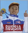  ??  ?? In this Feb. 15, 2014, file photo, men’s 1,000meter short track speedskati­ng gold medalist Viktor Ahn, of Russia, gestures while holding his medal during the medals ceremony at the Winter Olympics in Sochi, Russia. AP PHOTO/ DAVID J. PHILLIP