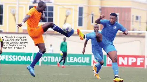  ??  ?? Olawale Abisoye (L) of Sunshine Stars fights for the ball with Samson Obi of Enyimba during their week 17 match