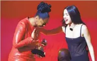  ?? Robert Gauthier Los Angeles Times ?? SAMARA JOY, left, accepts her new artist Grammy from Olivia Rodrigo, last year’s winner of the coveted prize.