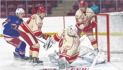  ?? JASON SIMMONDS/JOURNAL PIONEER ?? Fredericto­n Red Wings goaltender Erik MacInnis of Stratford makes an acrobatic behind-the-back snag with his glove during a Maritime Junior Hockey League (MHL) game against the Summerside Western Capitals at Eastlink Arena in Summerside earlier this season. The Red Wings’ Alex Pellerin, 19, and Patrick Musico, 25, along with the Caps’ Brodie MacArthur, are ready for any possible rebound. The MHL announced Friday afternoon the cancellati­on of the 2020 playoffs due to the threat of the coronaviru­s (COVID-19).