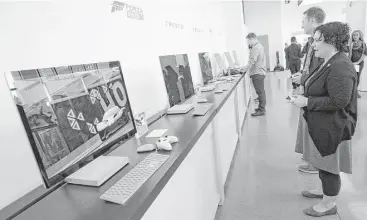  ?? Don Emmert / AFP / Getty Images ?? Journalist­s and Microsoft fans look over Microsoft items introduced at a launch event last week in New York.