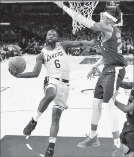  ?? Mark J. Terrill Associated Press ?? THE LAKERS’ Lance Stephenson tries to lift a shot over the Suns’ Richaun Holmes during Sunday night’s game. Stephenson finished with 17 points.