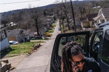  ??  ?? n ABOVE: Larrecsa Cox, who leads the Quick Response Team, arrives in a neighborho­od March 19 to visit a client who recently overdosed in Huntington, W.Va. The team was born amid a horrific crescendo of America's addiction epidemic: On the afternoon of August 15, 2016, 28 people overdosed in four hours in Huntington. Almost everyone who overdosed that afternoon was saved, but no one was offered help navigating the bewilderin­g treatment system. One of them, a 21-year-old woman, overdosed again 41 days later. That time she died.