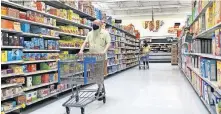  ?? GREEN/ THE OKLAHOMAN]. [JORDAN ?? Shoppers wearings masks walk through an Edmond Walmart.