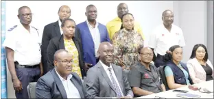  ?? ?? PS Mkhaliphi (seated L) and the Acting WHO Representa­tive Dr Geoffrey Bisoborwa(2nd L, seated) after handing over certificat­es to officers from different sectors, who were trained on Road Safety Auditing.