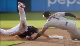  ?? TONY DEJAK — ASSOCIATED PRESS ?? The Astros’ Carlos Correa, right, tags out Melky Cabrera at second base in the fourth inning May 24 at Progressiv­e Field.