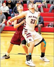  ?? Photograph­s courtesy of Russ Wilson ?? Senior Blackhawk Britton Caudill guards against a Pioneer player.