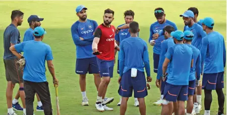  ?? (AFP) ?? Indian captain Virat Kohli speaks with teammates during a training session ahead of the first one-dayer against Australia in Chennai on Friday