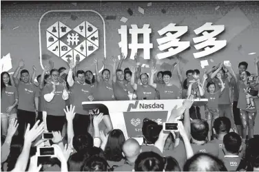  ?? PROVIDED TO CHINA DAILY ?? in July. E-commerce company Pinduoduo’s staff members celebrate the company’s listing on the Nasdaq Stock Market in the United States