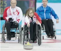  ?? LEAH HENNEL/ POSTMEDIA NEWS ?? Canada’s Sonja Gaudet takes a shot during Thursday’s wheelchair curling match against Finland in Sochi.