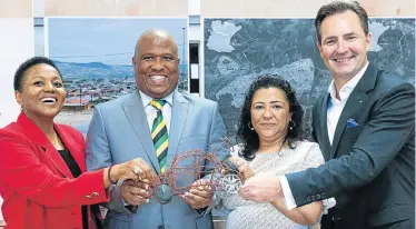  ??  ?? JOINING HANDS: At the B-BBEE Initiative­s Trust function are, from left, VW Group SA corporate and government affairs director Nonkqubela Maliza, finance MEC Oscar Mabuyane, KPL Die Casting owner Sally Marengo and VWSA chair and managing director Thomas Schaefer